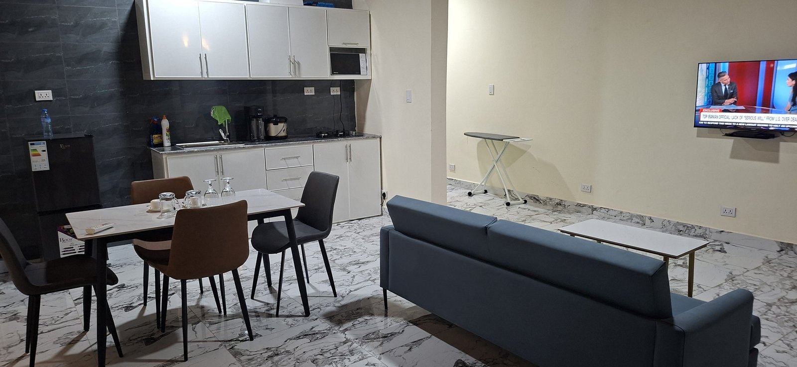 Inside an apartment at TEE Guest House — kitchen, dining and living area